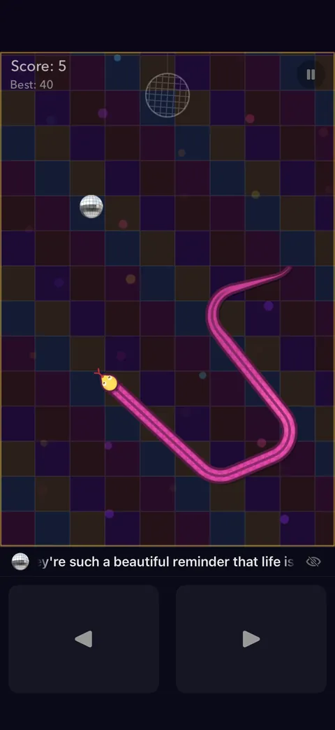A pink snake on a purple checkerboard arena, saying 'you're such a beautiful reminder that life is…'